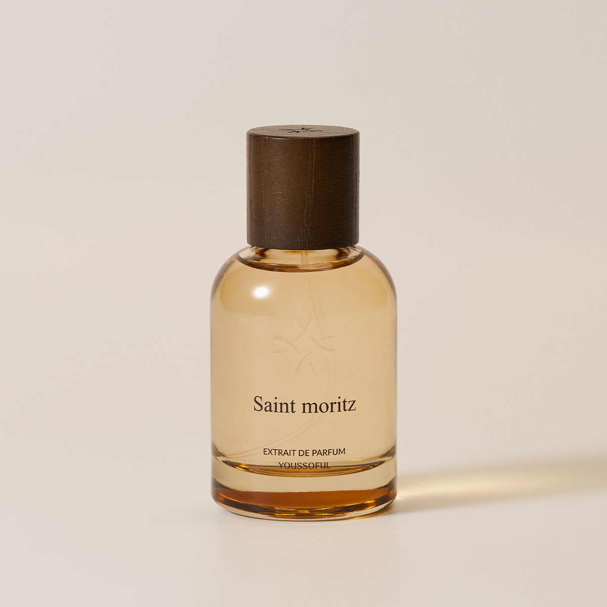YOUSSOFUL Saint Moritz Extrait de Parfum bottle with a dark wood cap