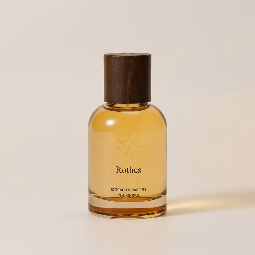 YOUSSOFUL Rothes Extrait de Parfum bottle with a dark wood cap
