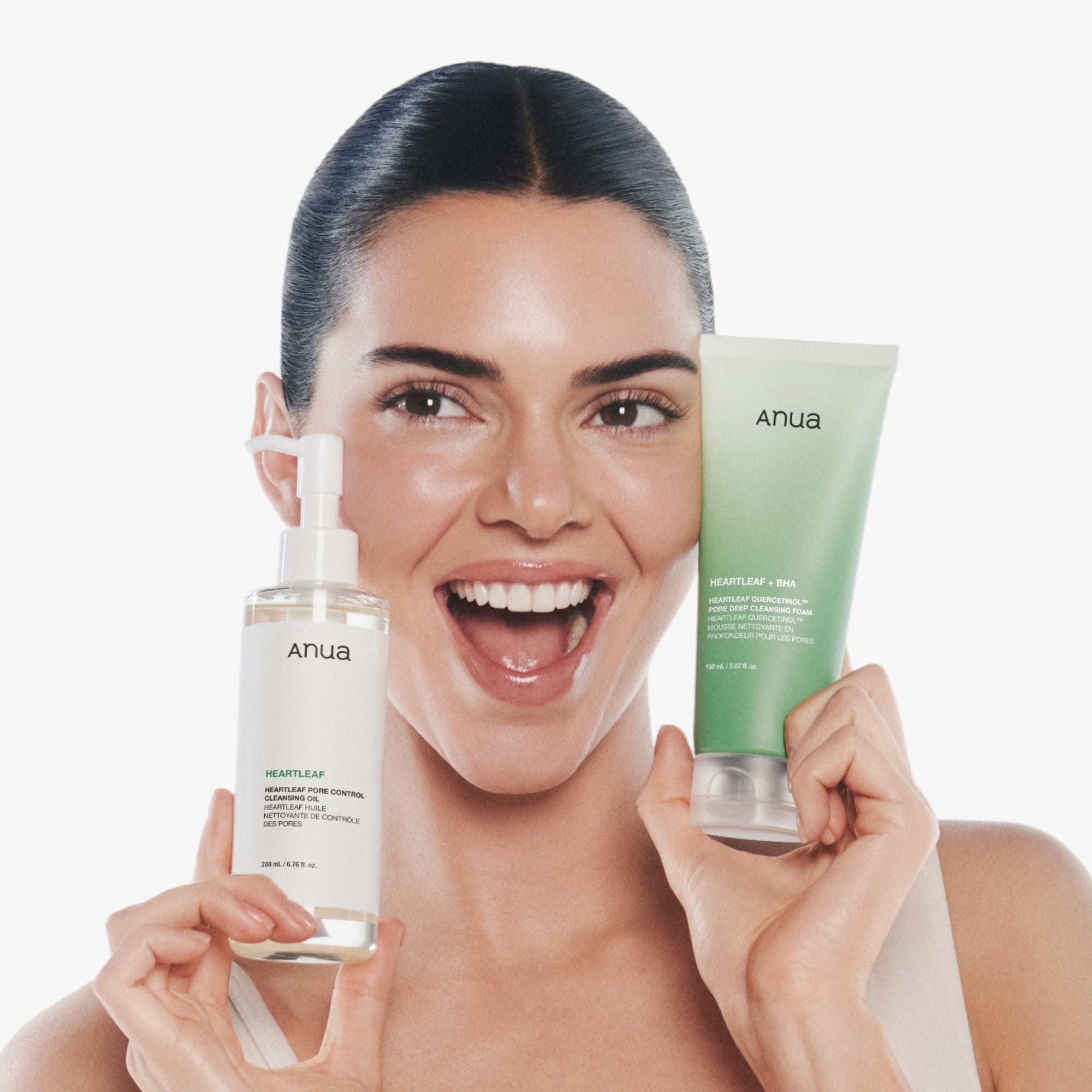 Official model holding the cleansing oil and separately sold foam cleanser.