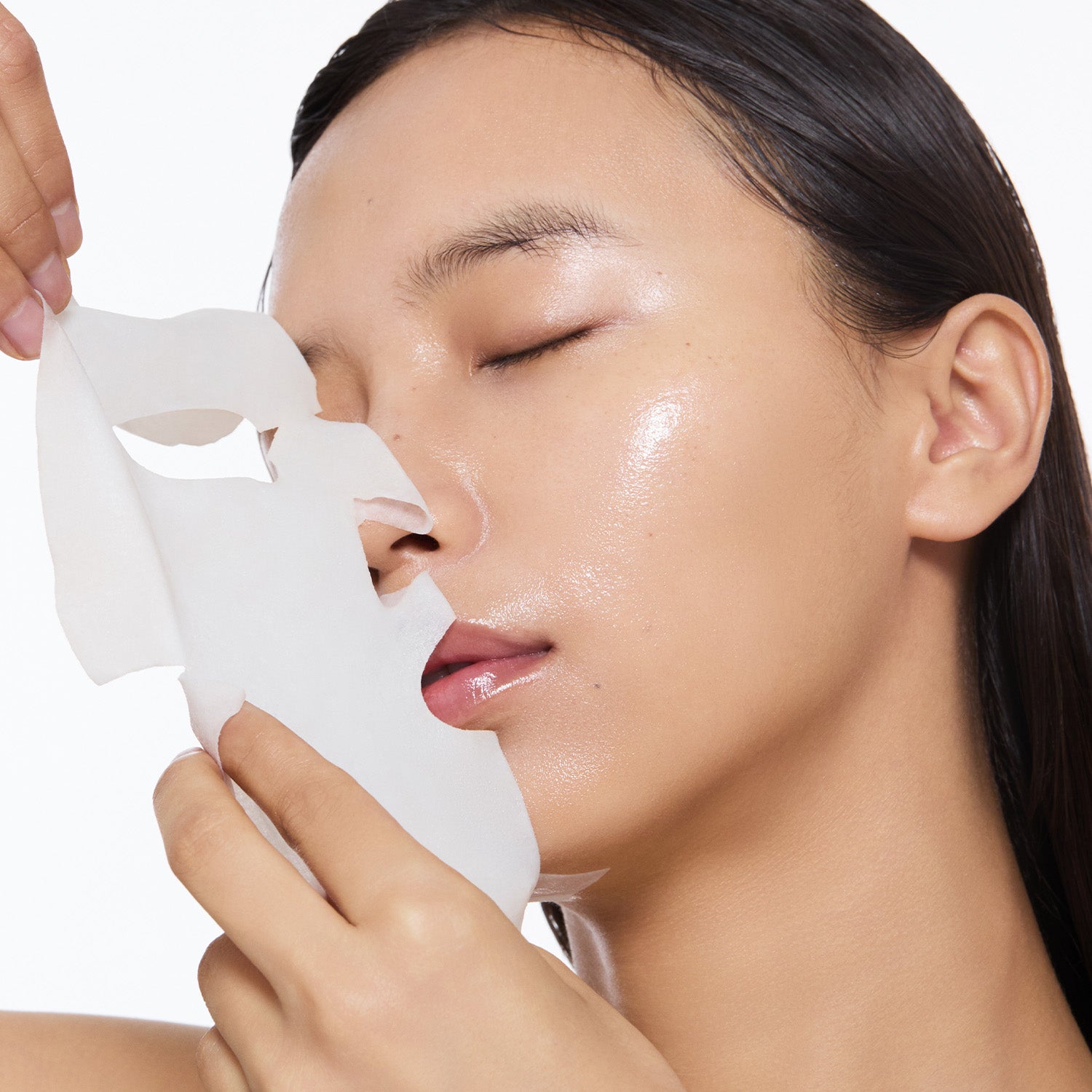 Model removing the mask sheet.
