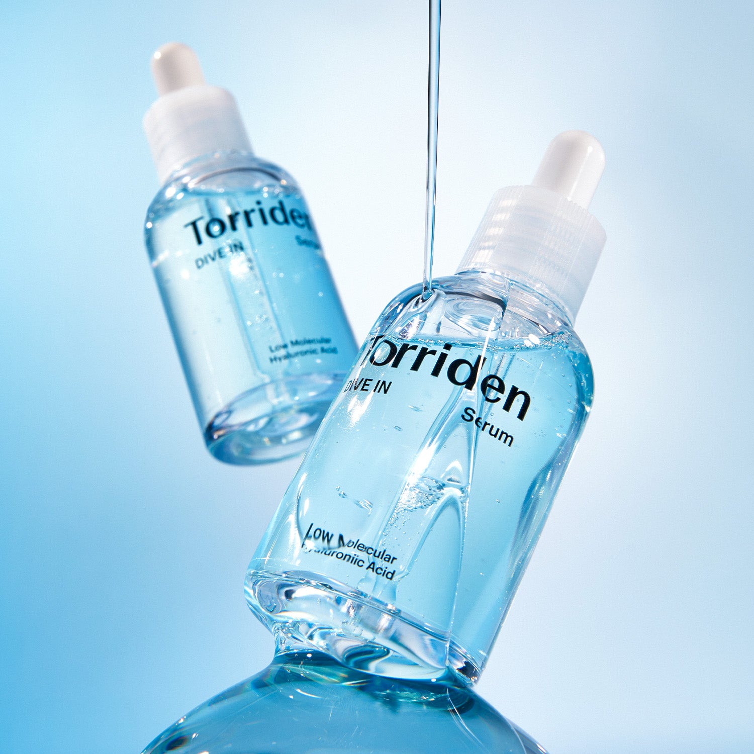 Serum bottles with a stream of product.